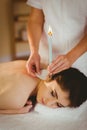 Young woman getting ear candling treatment Royalty Free Stock Photo