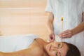 Young woman getting an ear candling treatment Royalty Free Stock Photo