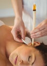 Young woman getting an ear candling treatment