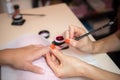 young woman getting a manicure applying semi-permanent nail polish