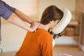 Young woman getting massage in chair