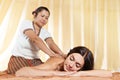 Young woman getting massage in Thai spa.