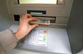 Young woman while she getting money from ATM Royalty Free Stock Photo