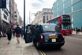 Young woman getting out of the taxi