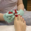 Young woman getting professional pedicure in beauty salon, closeup Royalty Free Stock Photo