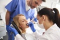 Young woman is getting treatment in dentist`s office