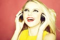 Pretty blonde dg girl in headset on pink Royalty Free Stock Photo