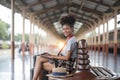 Young woman girl female sitting use computer laptop and travel bag suit case on the floor at station Royalty Free Stock Photo