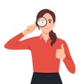 Young woman or girl holding a magnifying glass and making thumbs up gesture sign. Person showing magnifier lens. Female character Royalty Free Stock Photo