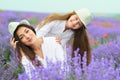 Young woman and girl are in the lavender field, beautiful summer landscape with red poppy flowers Royalty Free Stock Photo