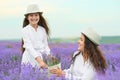 Young woman and girl are in the lavender field, beautiful summer landscape with red poppy flowers Royalty Free Stock Photo