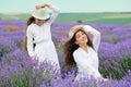 Young woman and girl are in the lavender field, beautiful summer landscape with red poppy flowers Royalty Free Stock Photo