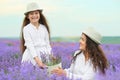 Young woman and girl are in the lavender field, beautiful summer landscape with red poppy flowers Royalty Free Stock Photo