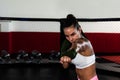 Young woman or girl mixed martial arts boxer fighter training in the octagon cage. Female bare knuckle boxing workout Royalty Free Stock Photo