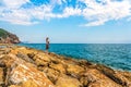 Young woman or girl on a rocky seashorein Alanya resort, Turkey Royalty Free Stock Photo