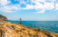 Young woman or girl on a rocky seashorein Alanya resort, Turkey Royalty Free Stock Photo