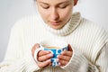 Young woman girl in a warm sweater with a cup of hot coffee. on white Royalty Free Stock Photo