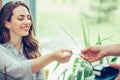 Young woman giving credit card to waiter hand and paying for coffee at cafe Royalty Free Stock Photo