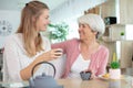 young woman giving tea at mum