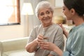 Young woman giving water to elderly lady. Senior people care Royalty Free Stock Photo