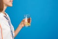 Young woman with glass of lemon water on blue background, closeup. Space for text Royalty Free Stock Photo