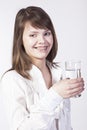 Young woman with glass of water on a white