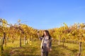 Young woman with a glass of white wine in the vineyards of Italy. Person pouring wine. Free space for text. Royalty Free Stock Photo