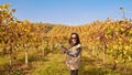 Young woman with a glass of white wine in the vineyards of Italy. Person pouring wine. Free space for text. Royalty Free Stock Photo