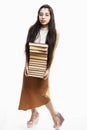 A young woman with glasses holds a large pile of books in her hands. Brunette with long hair. Training and education. Isolated on Royalty Free Stock Photo