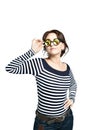 Young woman with glasses of kaleidoscopes in a striped tight blouse holds on to the shackle of glasses. Royalty Free Stock Photo