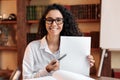 Young woman with glasses pointing to a sheet of paper Royalty Free Stock Photo