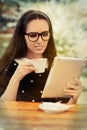 Young Woman with Glasses and Tablet Having Coffee Royalty Free Stock Photo