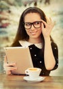 Young Woman with Glasses and Tablet Having Coffee Royalty Free Stock Photo