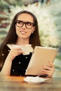 Young Woman with Glasses and Tablet Having Coffee Royalty Free Stock Photo