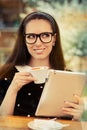 Young Woman with Glasses and Tablet Having Coffee Royalty Free Stock Photo