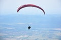 Young woman gliding in the sky above the town of Sopot, Bulgaria