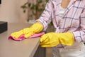 young woman cleaning table with microfiber cloth. Royalty Free Stock Photo