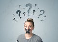 Young woman with glued mouth and question mark symbols Royalty Free Stock Photo