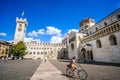 Young woman go bicycle in Piazza Duomo, Trento. Travel by bicycle in Italy, cultural trip in Italy Royalty Free Stock Photo