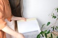 Young Woman Goes Through Documents In Home Archive, Looking For The Right Fol, hands are sorting through thin files with