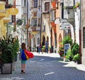 Young woman goes shopping in the street of Hall