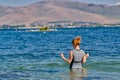 Young Woman going swimming in Lake Sevan of Armenia