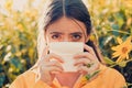 Young woman is going to sneeze. The girl suffers from pollen allergy during flowering and uses napkins. Pretty woman got Royalty Free Stock Photo