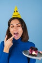 Young woman in golf on a blue background celebrates a birthday