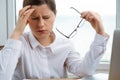 Young woman got headache at work. Finance problems, crisis coming Royalty Free Stock Photo