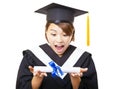 Young woman graduating holding diploma and looking Royalty Free Stock Photo