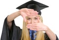 Young woman in graduation gown framing with hands Royalty Free Stock Photo