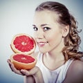 Young woman with grapefruit