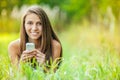 Young woman grass lying with phone Royalty Free Stock Photo