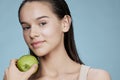 young woman green apple near face health isolated background Royalty Free Stock Photo